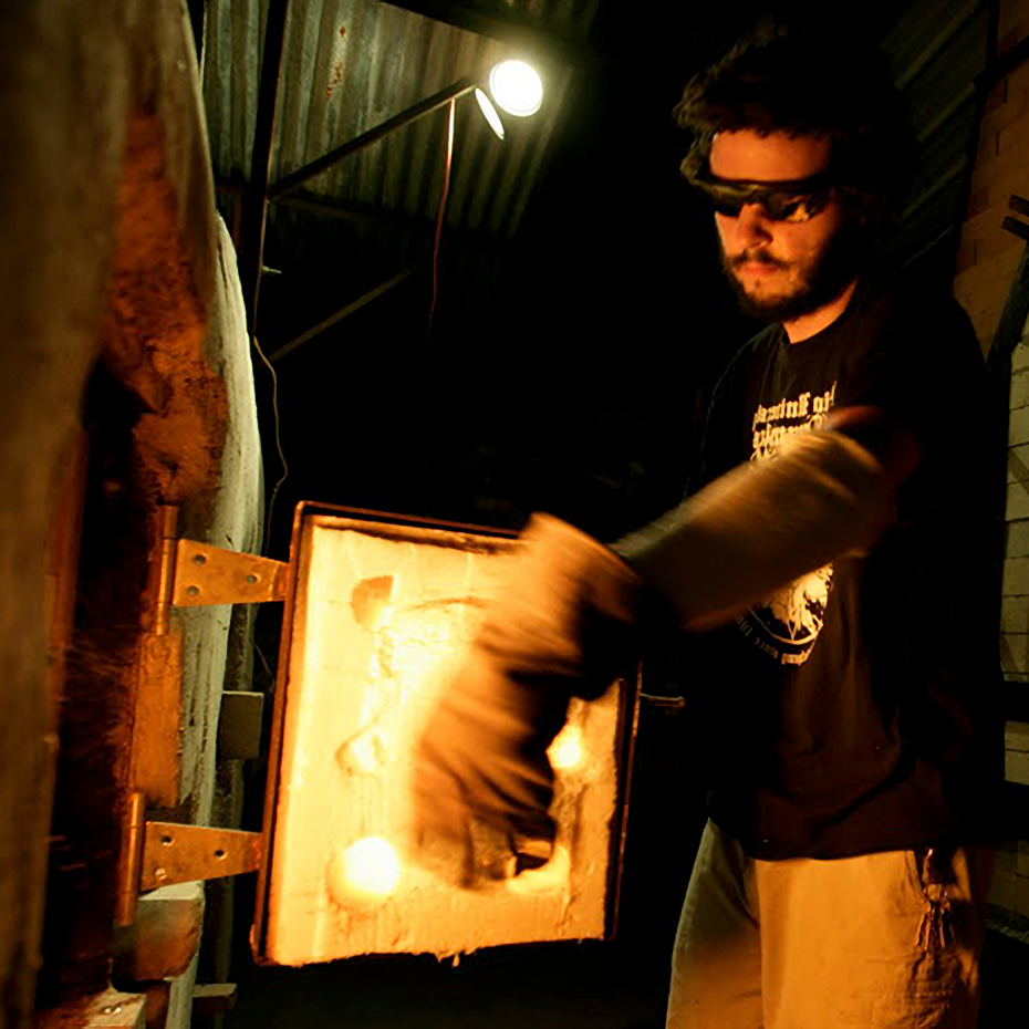 artist loading ceramics kiln